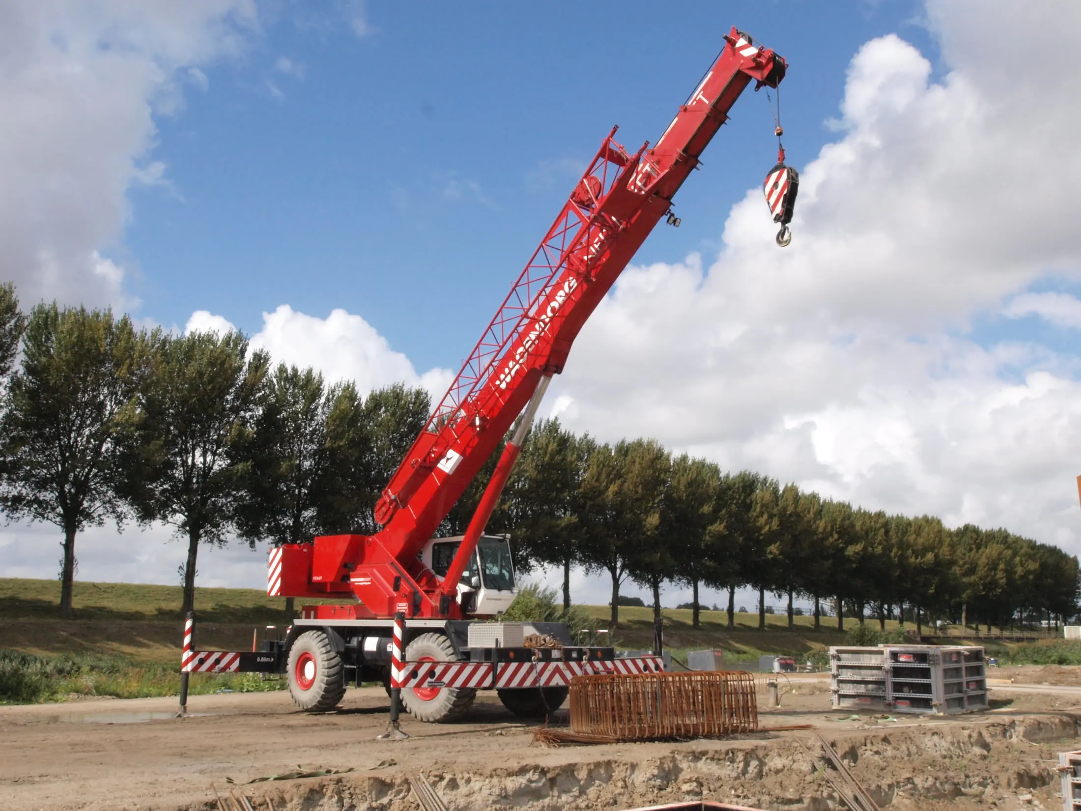 Crane with its boom raised on a job site